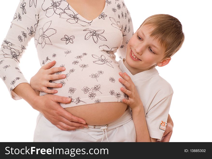 Son with surprise hugs belly of his pregnant mother on a white background. Son with surprise hugs belly of his pregnant mother on a white background