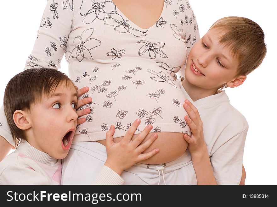 Children with surprise hugs belly of pregnant mother. Children with surprise hugs belly of pregnant mother