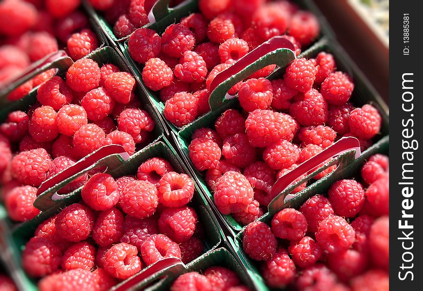 Raspberries in small cases on a french market