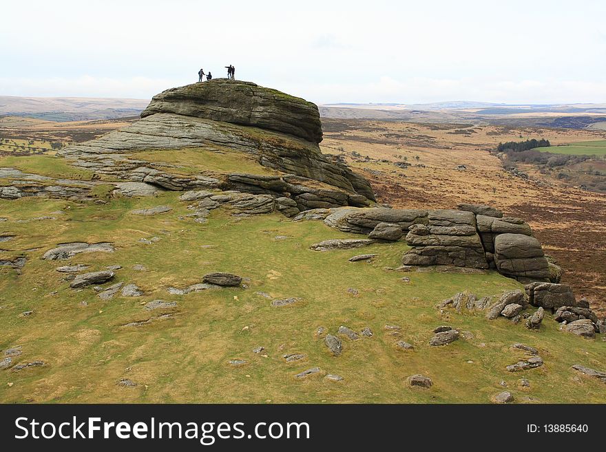 Group of people on the top of a rocky hill. Group of people on the top of a rocky hill