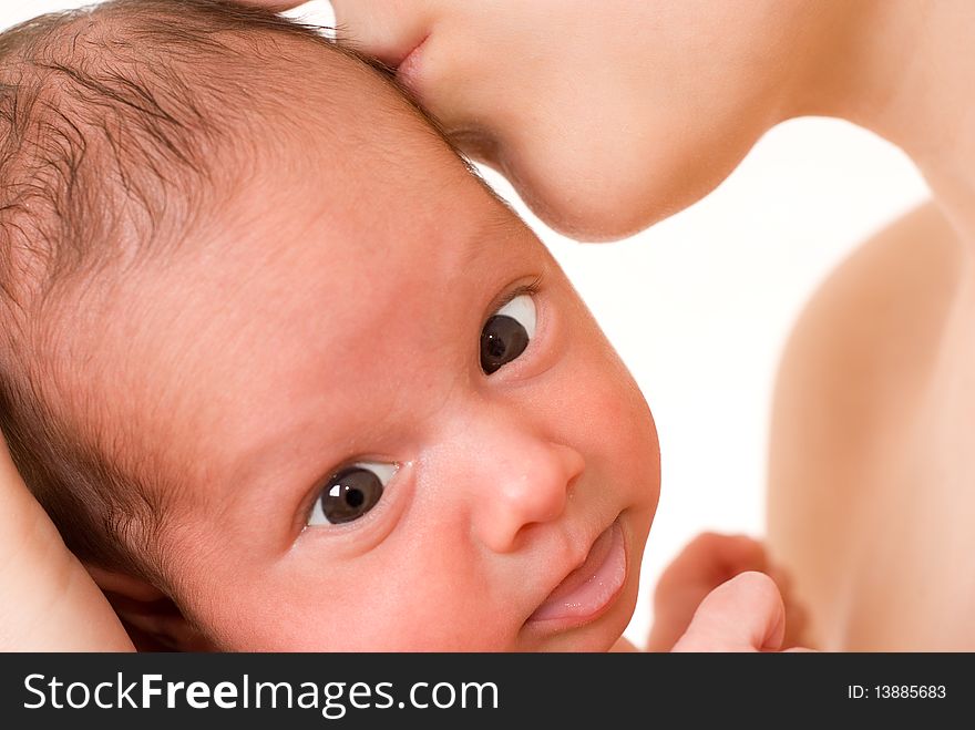 Mother holds baby with brown eyes on his hands