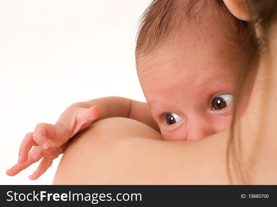 Mother holds nice baby with brown eyes