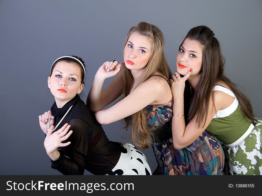 Three happy retro-styled girls in studio