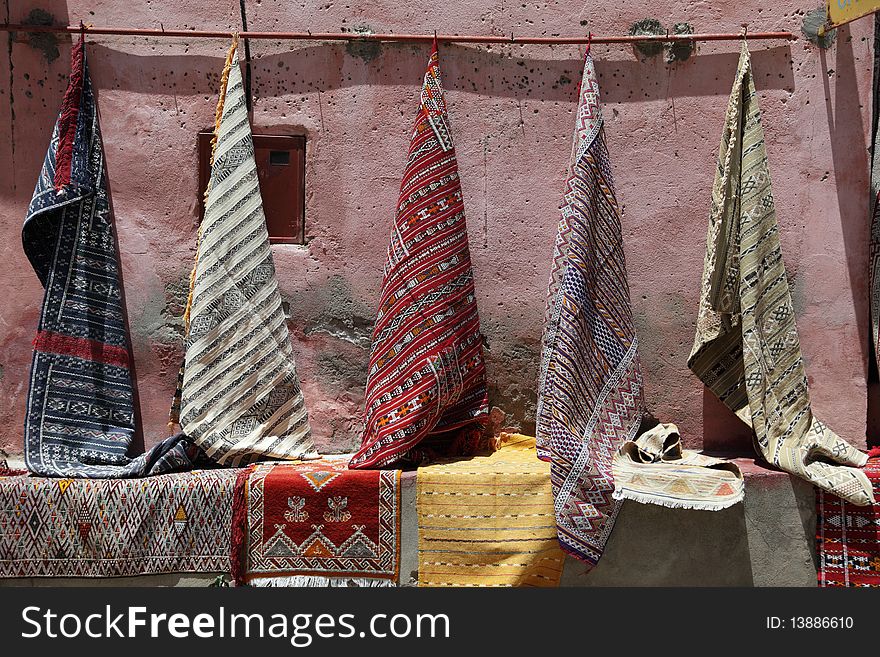 Moroccan rugs for sale as a market.
