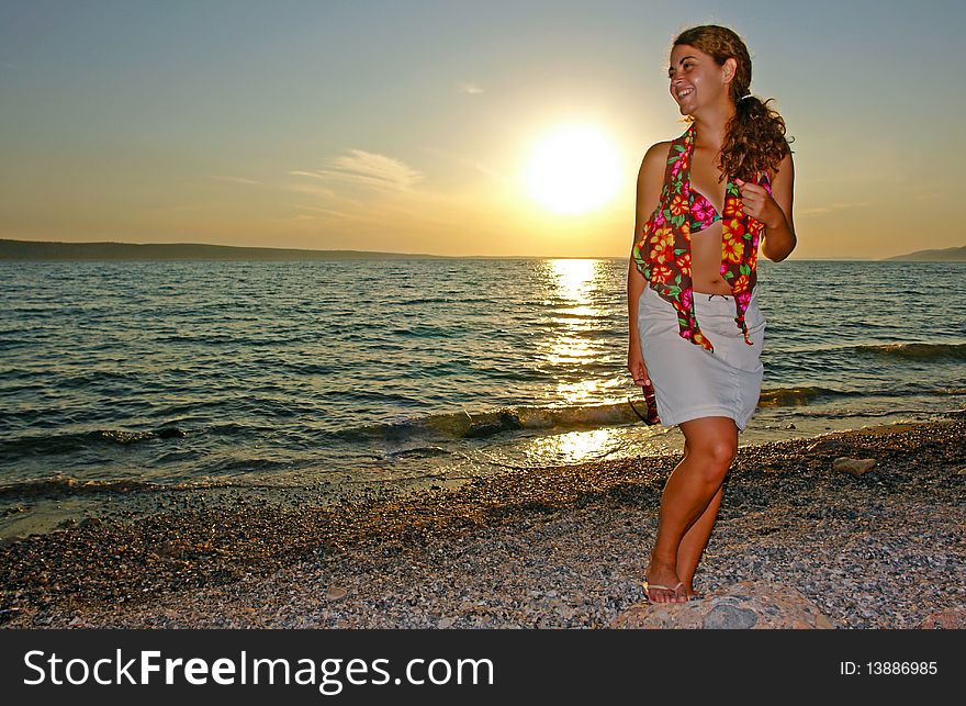 Happy young model keep smiling at the beautiful sunset beach. Happy young model keep smiling at the beautiful sunset beach.