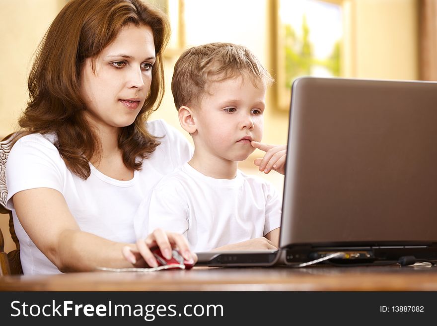 Mother with her son using laptop. Mother with her son using laptop