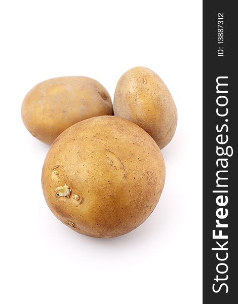 Three potatoes isolated on white background.