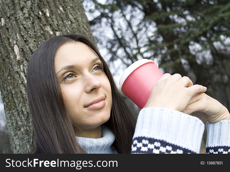 Beautiful girl sunny day in the park drinking coffee from paper cups. Portrait. Beautiful girl sunny day in the park drinking coffee from paper cups. Portrait