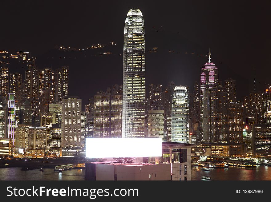 Illuminated Hong Kong Island skyline with reflections at night. Illuminated Hong Kong Island skyline with reflections at night