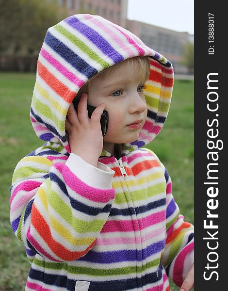 Little girl talking on the phone for a walk