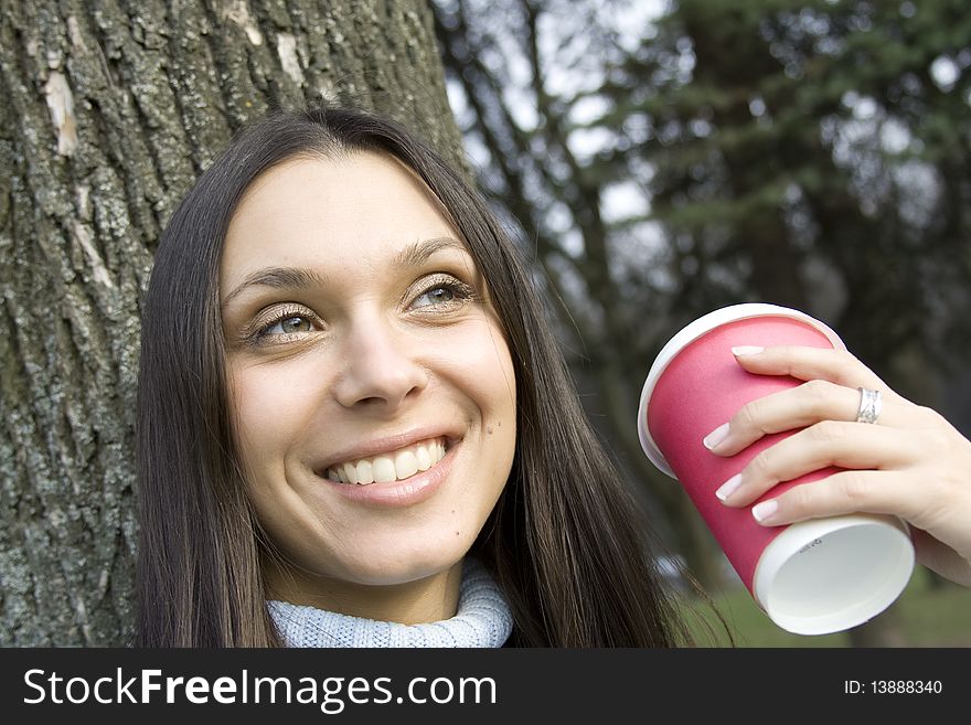 Female In A Park Drinking Coffee