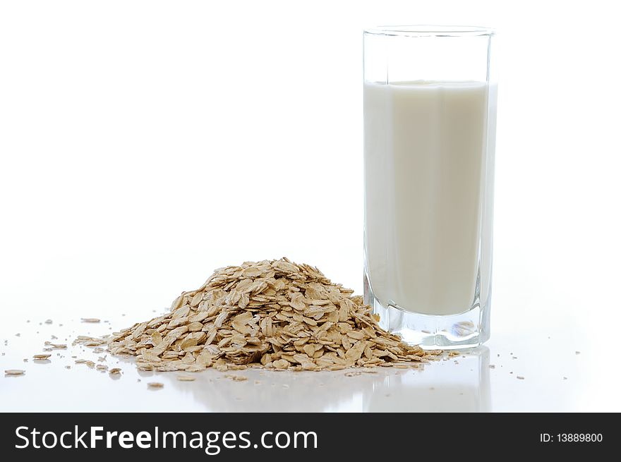 Oat flakes with the milk against the white background