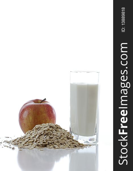 Oat flakes with the milk and apple  against the white background. Oat flakes with the milk and apple  against the white background