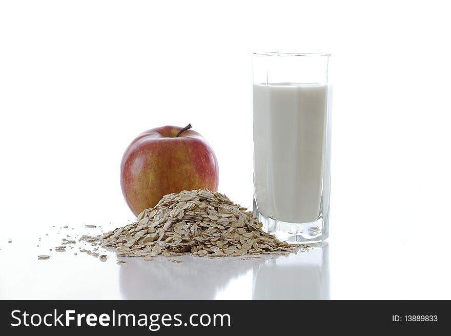 Oat flakes with the milk and apple  against the white background. Oat flakes with the milk and apple  against the white background