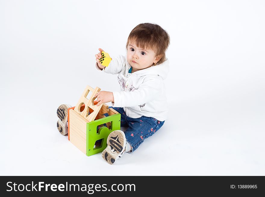 Little girl playing with puzzle cube