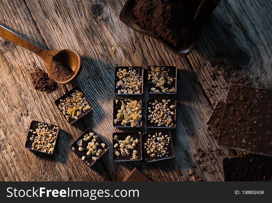 Composition of  Chocolate made at home, rustic woodenbackground.