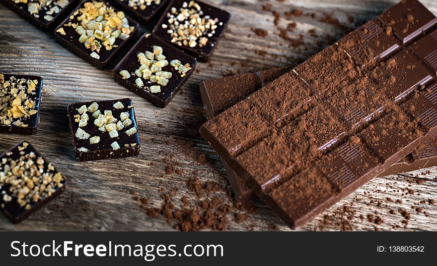 Composition of  Chocolate made at home, rustic woodenbackground.