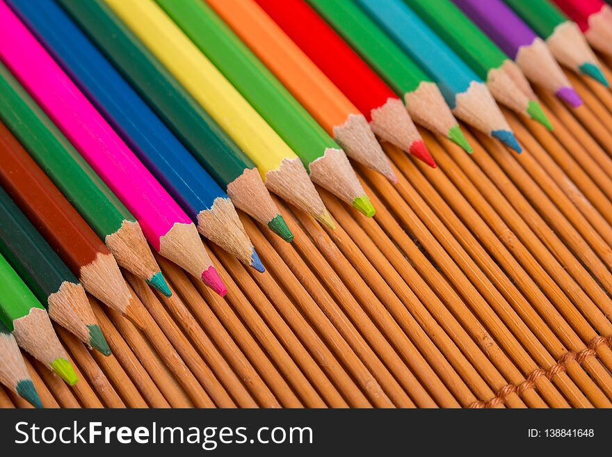 Wooden colorful pencils, on wooden table