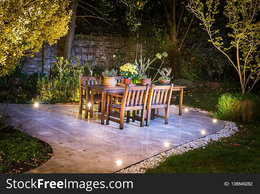 Lovely terrace outside luxury house during the night time. Lovely lights and trees