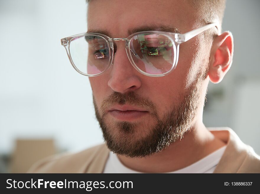Young man wearing glasses on blurred background