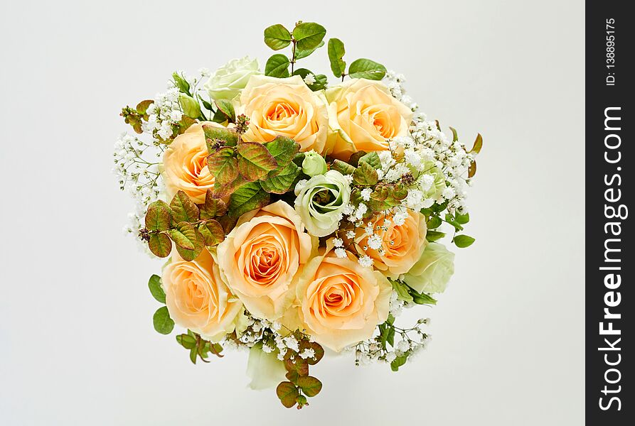 Beautiful wedding bouquet of roses, viewed in close-up from above on white background