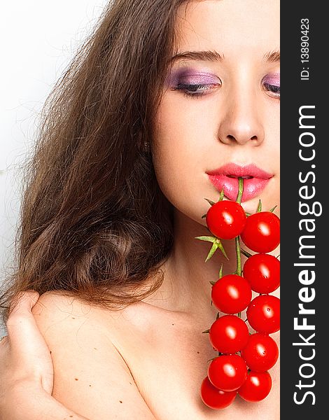 Young sexy girl with cherry tomatoes