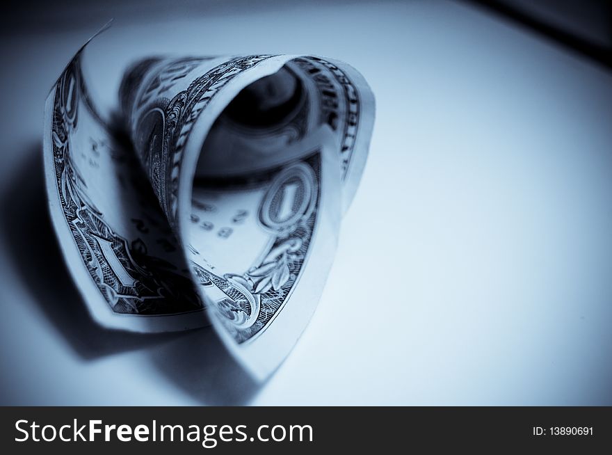 A rolled up one dollar bill isolated on a white background