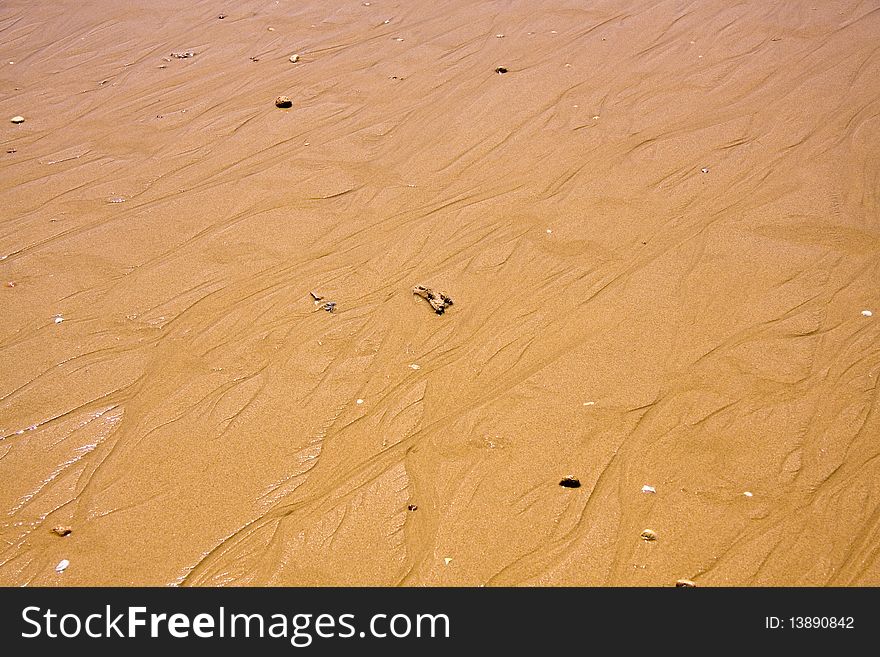 Yellow sand and stones on the beach