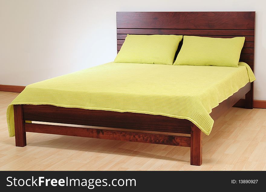 Brown bed with green spreads. Brown bed with green spreads.
