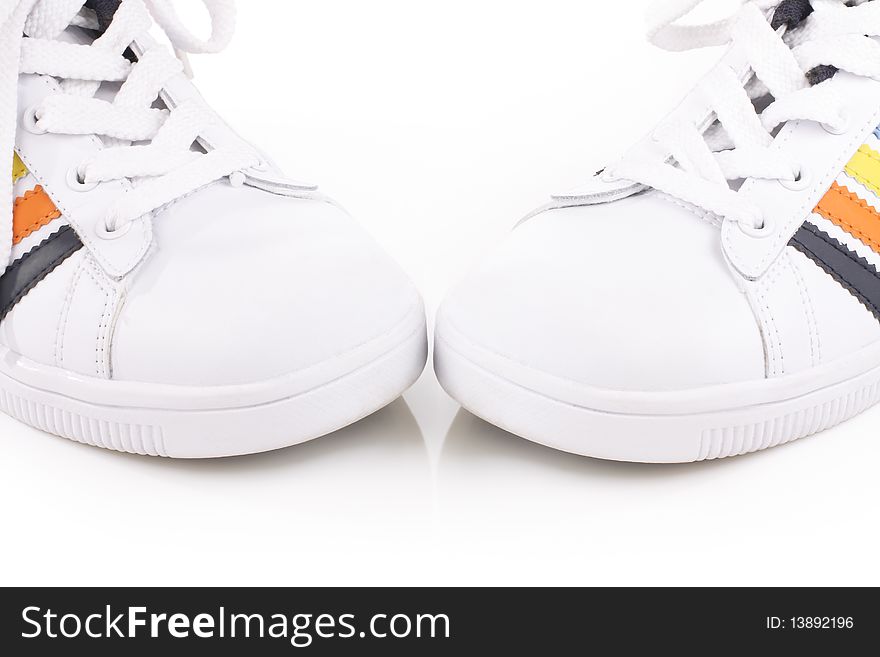 Athletic shoes with colorful stripes on a light background