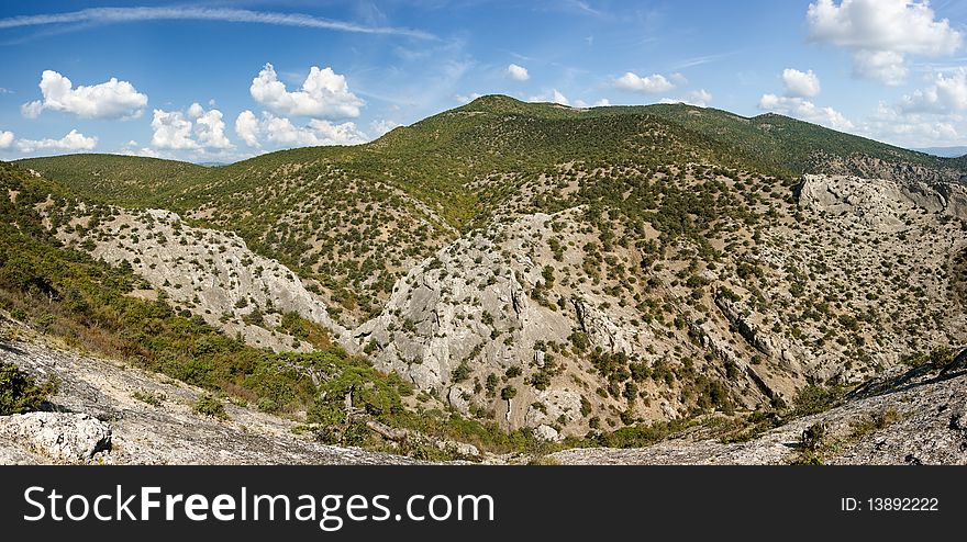 Crimea mountains with pine trees and juniper under blue sky. Crimea mountains with pine trees and juniper under blue sky