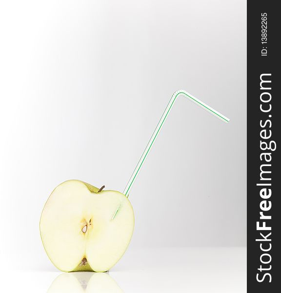Sliced juicy apple with drinking straw. Sliced juicy apple with drinking straw