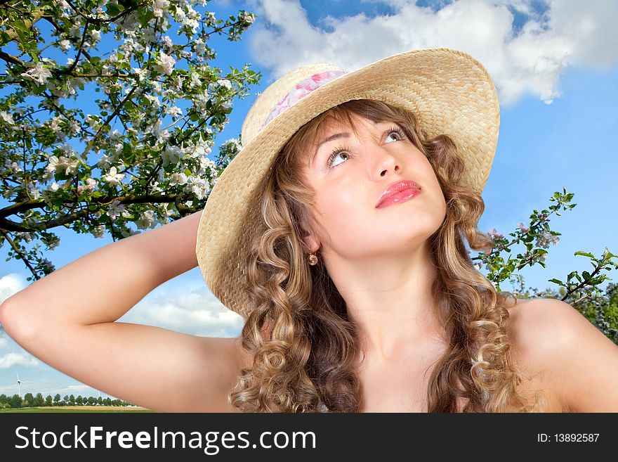 Closeup portrait of a cute young woman wearing a straw hat