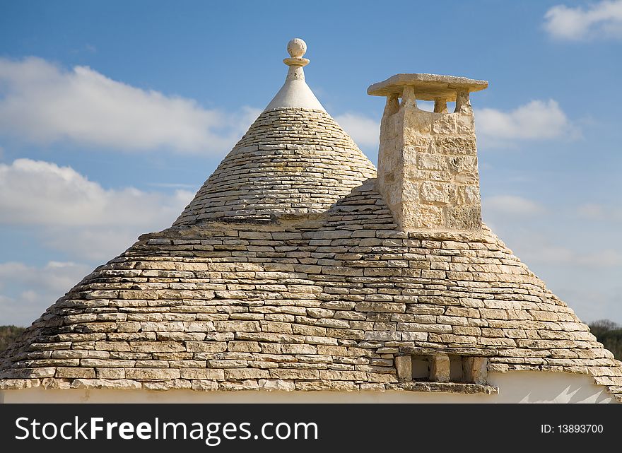 Conical shaped roof of a trullo, a traditional stone made house, trasitional for Puglia, Italy