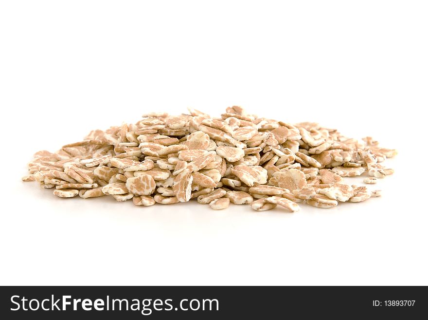 Organic wheat flakes isolated on white background.