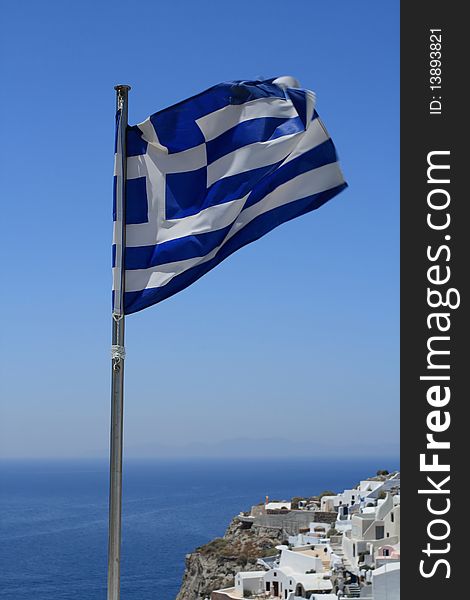 Greek flag over santorini greek island