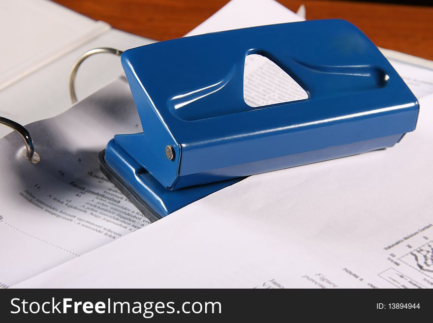 Blue puncher in a portfolio in a desk.