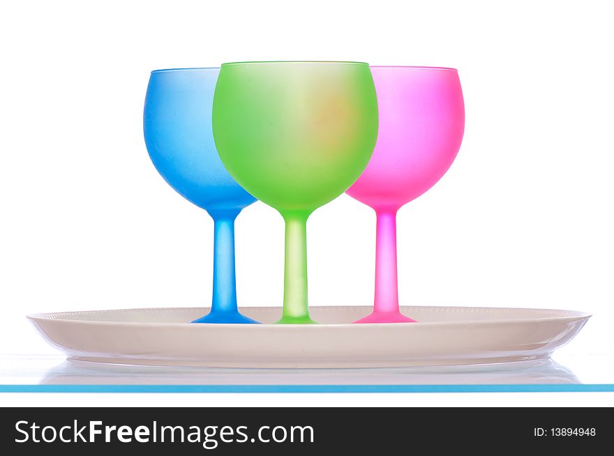 Three colored glasses for cocktails on the plate for party