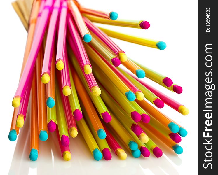 Pile of colorful matches, reflected from the white surface. Pile of colorful matches, reflected from the white surface