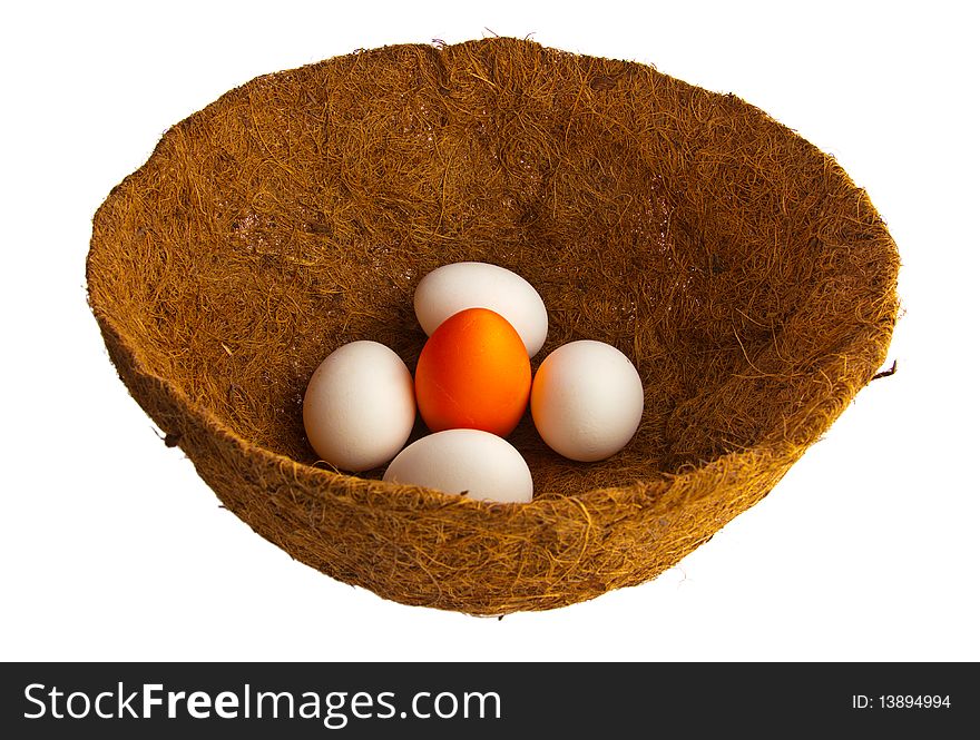 White and orange easter eggs in a decorative nest. White and orange easter eggs in a decorative nest