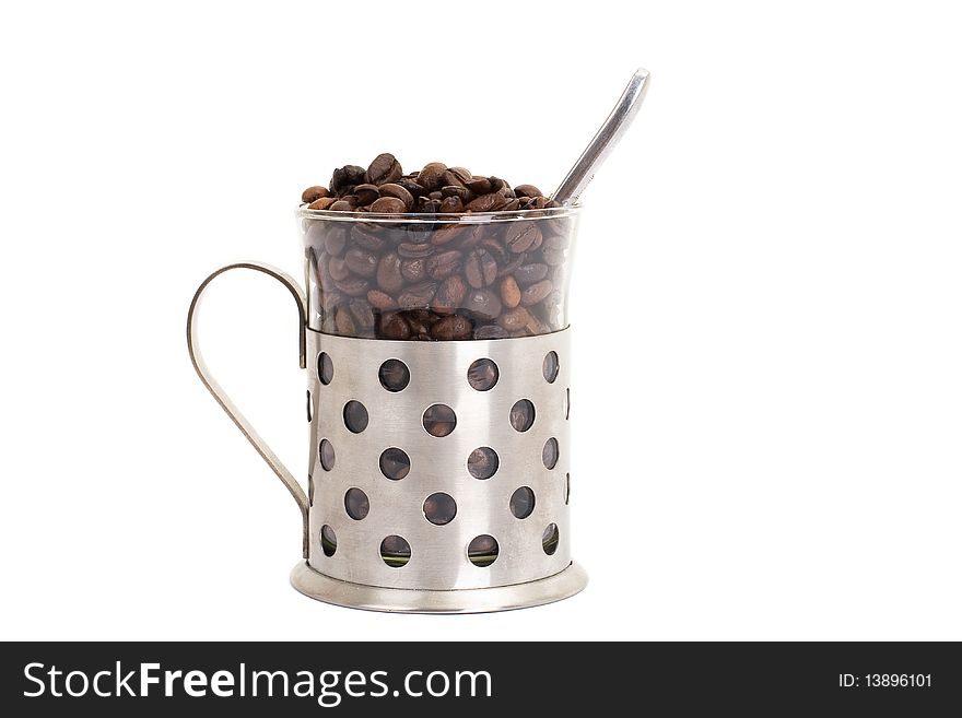 Glass cup with coffee and beans isolated on white
