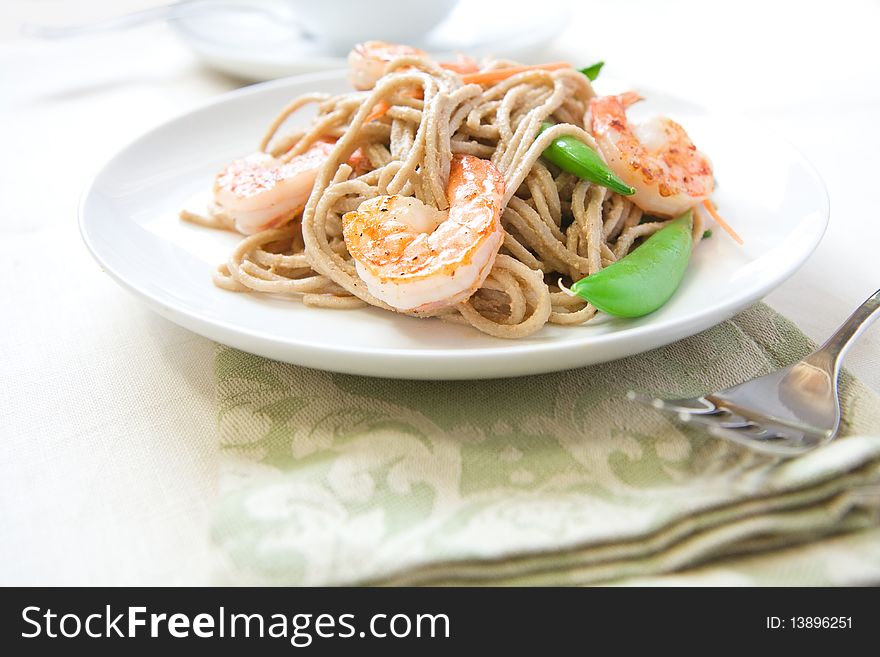 Cold soba noodle salad with shrimp, peas, and carrots