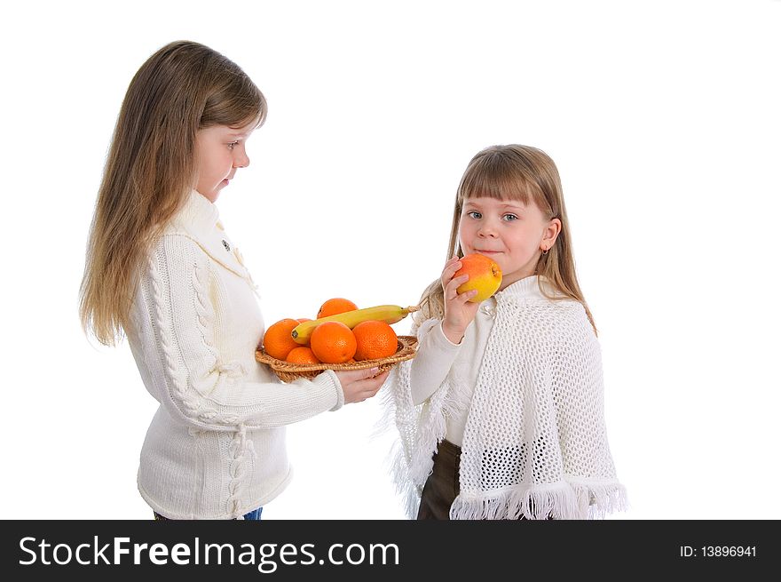 Two cheerful little girls with fruits