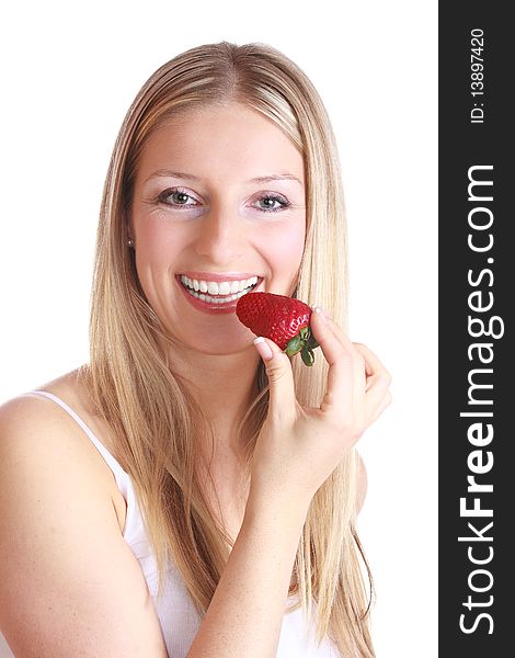 Caucasian blond woman eating strawberry