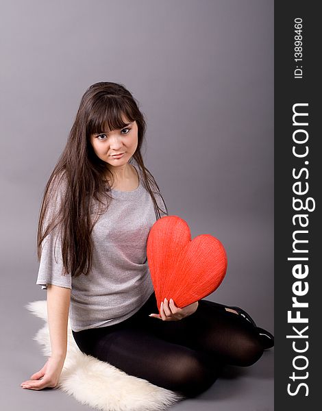 Beautiful woman holding red heart