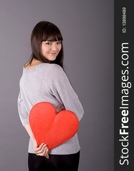 Beautiful woman holding red heart