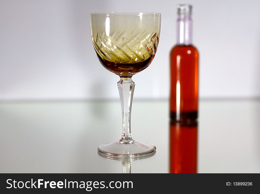 Small liquor bottle and glass. Small liquor bottle and glass