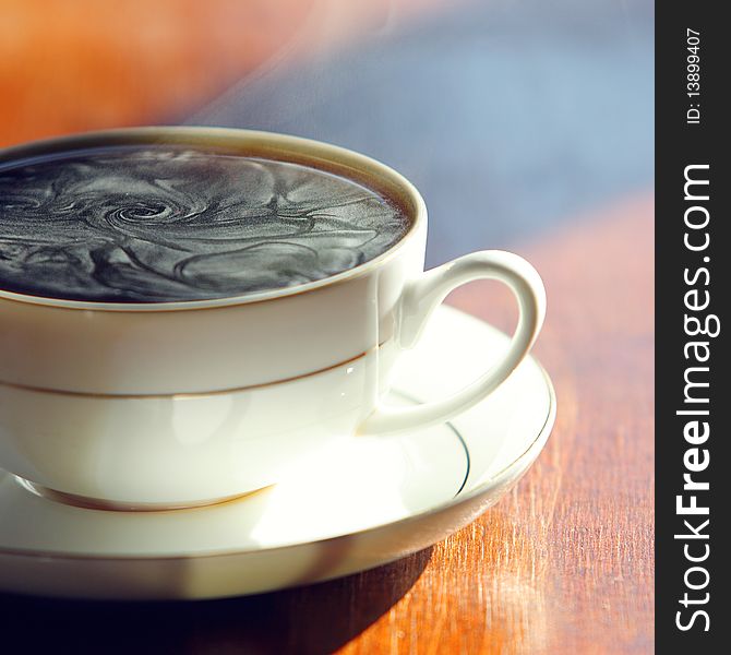 Black coffee. Cup of hot fragrant coffee on a table