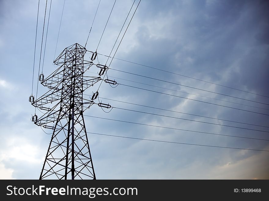 Silhouette Of Electrical Pylon And Blue Sky