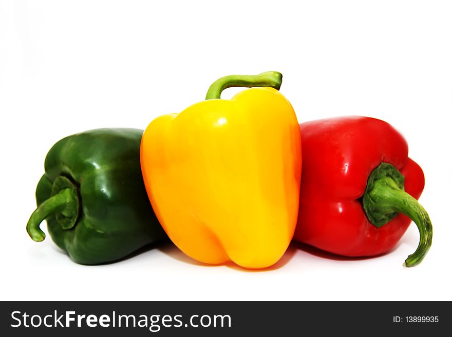 Green, yellow and red pepper on white background. Green, yellow and red pepper on white background
